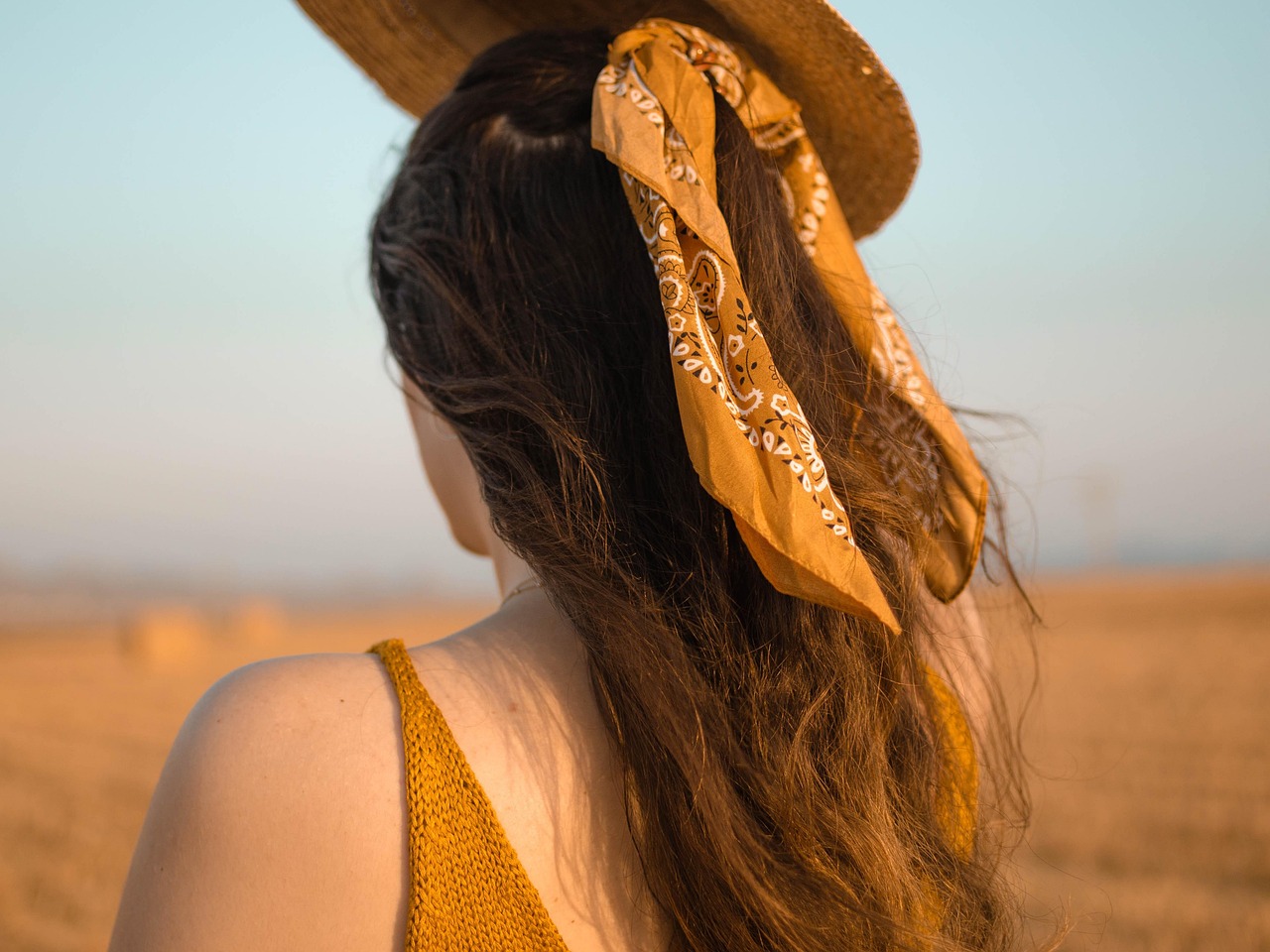 Femme portant un foulard en soie noué en bandeau dans les cheveux